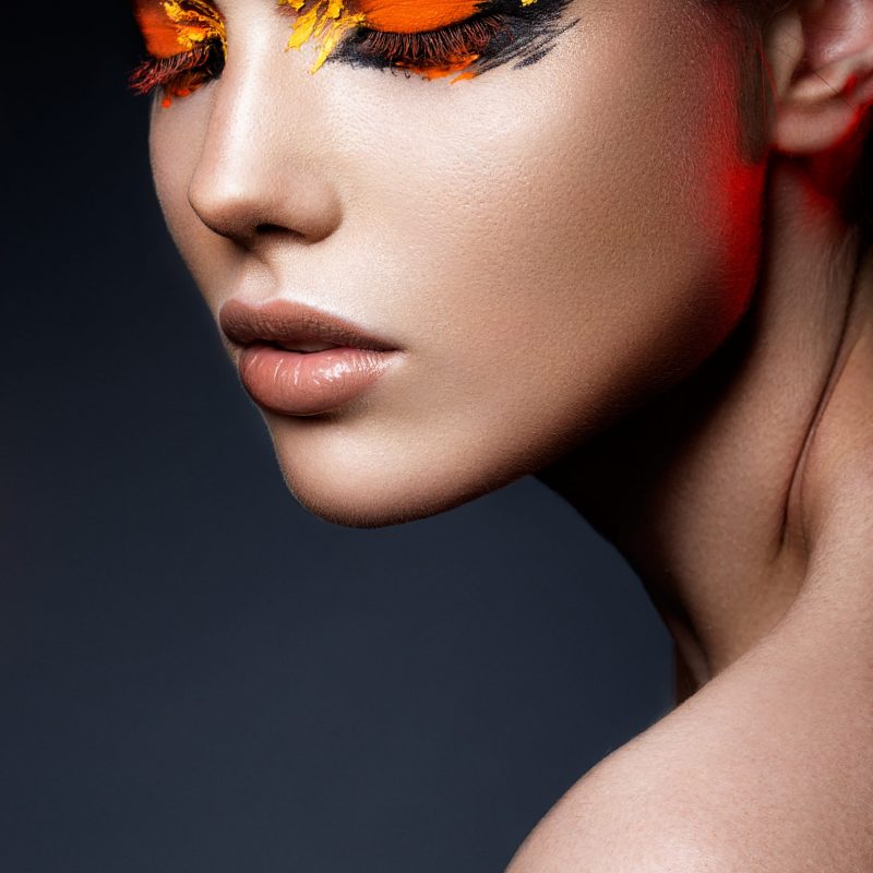 Beauty fashion model girl with dark bright orange make-up. Close up portret.